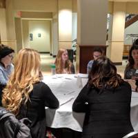 Students discussing their resume at the Cover Letter and Resume Roundtable Event